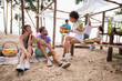 Full body photo of group friendly positive people enjoy hanging out sand beach party chatting communicate outdoors