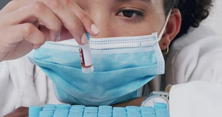 Wall Mural - scientist with face mask working with blood sample, dna testing or virus research in a modern lab. b