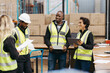 © Jacob Lund - Diverse warehouse workers having a meeting together