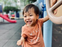 Portrait Of Cute Boy Standing On Footpath. Portrait Of Boy Playing In Playground Outdoors