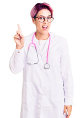 Poster - Young beautiful woman with pink hair wearing doctor uniform showing and pointing up with finger number one while smiling confident and happy.