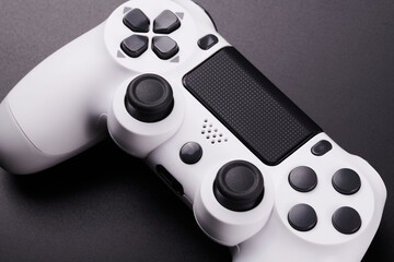 White video game controller, joystick for game console isolated on black background. Gamer control device close-up