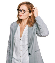 Wall Mural - Young caucasian woman wearing business style and glasses confuse and wondering about question. uncertain with doubt, thinking with hand on head. pensive concept.