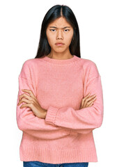 Poster - Beautiful young asian woman wearing casual winter sweater skeptic and nervous, disapproving expression on face with crossed arms. negative person.