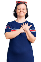 Sticker - Brunette woman with down syndrome wearing casual clothes smiling with hands on chest with closed eyes and grateful gesture on face. health concept.