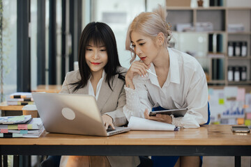 Technology and financial advisory services concert. Businesswoman teamwork and working on digital laptop computer with advisor showing plan of investment to clients at table office. Digital marketing.