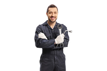 Wall Mural - Car mechanic holding a wrench and a key tool