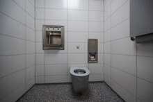 Interior Of New And Modern Clean Public Restroom With White Tiles And Stainless Steel Bowl