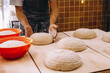 © ADDICTIVE STOCK - Crop male cook shaping dough with proofing basket