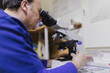© ADDICTIVE STOCK - Doctor looking through microscope in laboratory