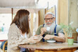 © ADDICTIVE STOCK - Hipster grandfather with granddaughter drinking coffee at cafe