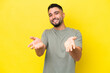 Young Arab handsome man isolated on yellow background happy and smiling