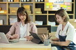 © SOMKID - Businesswoman working with packaging box at home office, Business online influencer on social media concept, Online Selling, Online Shopping to market,