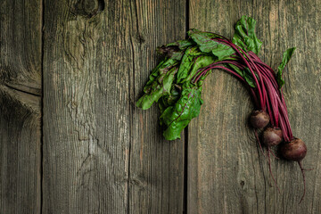 Sticker - Raw beetroot with herbage leaves on a dark background. banner, menu, recipe place for text, top view