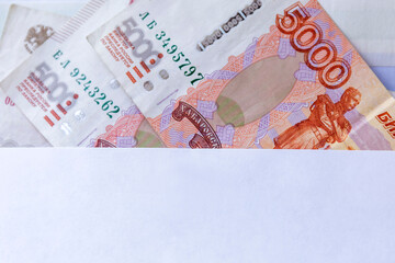 Wall Mural - 5000 ruble banknotes in an envelope. Investments and savings. Close-up.