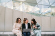 © ADDICTIVE STOCK - Group of female entrepreneurs working together on project in city