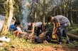 © ADDICTIVE STOCK - Diverse friends making campfire near tent in woods