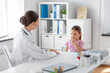 © Syda Productions - medicine, healthcare and pediatry concept - female doctor or pediatrician and coughing little girl patient on medical exam at clinic