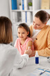 © Syda Productions - medicine, healthcare and pediatry concept - female doctor or pediatrician disinfecting arm skin of little girl patient with mother at clinic