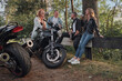 © perfectlab - Meeting A company of friends of motorcyclists bikers on motorcycles stopped on the roadside having fun and drinking tea