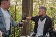 © perfectlab - Two man friends of motorcyclists bikers on motorcycles drinking tea from a thermos on the side of the road and talking
