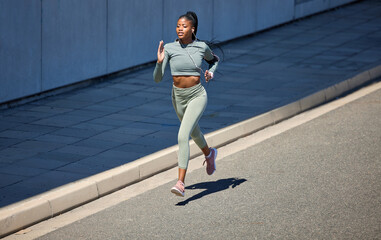 Canvas Print - City street, fitness and running woman with earphones listening to music or motivation audio for health workout with outdoor mockup. Black woman jogging or exercise training with a wellness podcast