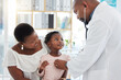 © Nina Lawrenson/peopleimages.com - Heart doctor, mother and child at a hospital for checkup, examination or medical advice at a clinic. Black healthcare man in cardiology checking little girl patient in medicare, examine appointment.