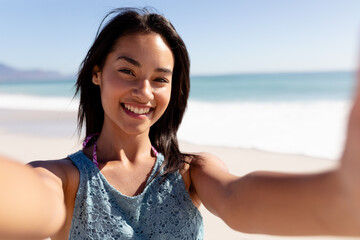 Wall Mural - Caucasian woman standing on the beach