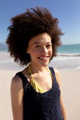 Wall Mural - Mixed race woman standing on the beach