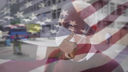 Wall Mural - Animation of flag of usa waving over caucasian man wearing face mask in city street