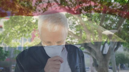 Poster - Animation of flag of netherlands waving over caucasian man wearing face mask in city street