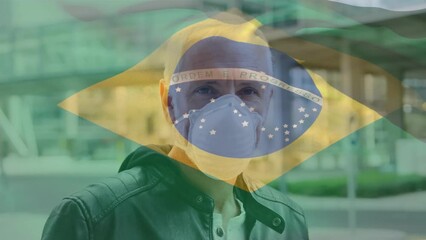 Poster - Animation of flag of brazil waving over caucasian man wearing face mask in city street