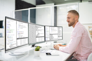 Computer Programmer Writing Program Code On Computer