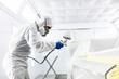 © Wavebreak Media - Mixed race car painter painting a car