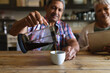 © Wavebreak Media - Senior african american couple pouring coffee and using digital tablet in kitchen