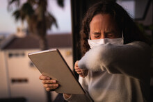Woman Wearing A Face Mask At Home. Social Distancing In Quarantine During Coronavirus Epidemic
