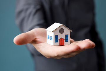 Model house in man hand