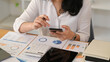 © Prathankarnpap - Young woman financial advisor using chatting online with her client on her mobile phone