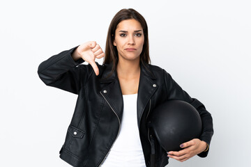 Sticker - Caucasian girl holding a motorcycle helmet on white background showing thumb down sign