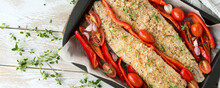 A Baking Sheet With Cod Fillet With Bell Peppers And Tomatoes On A Light Table