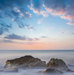 sea coast with stones at the sunset, long exposure outdoor scene