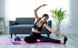 © wichayada - Portrait of young beautiful asian woman stretching warm up exercise workout yoga position at home in living room. Sporty asia girl health care lifestyle.