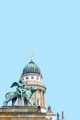 Cover page with statue of panther with genius of music, angel with wings and harp, stringed musical instrument at Concert Hall at French Church in Berlin, Germany with blue sky background copy space.