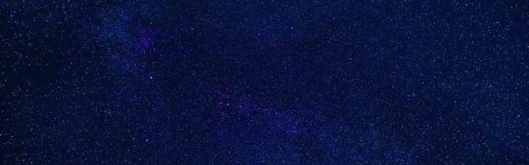 Wall Mural - Starry Milky Way at night with stars on the background of a dark blue night sky