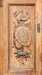 Detail of the decoration of the wooden door shutter at the entrance of the Sacra di San Michele abbey in Susa Valley, Italy