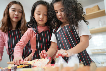 family activities make a cake in the kitchen, child making cake with family. family fun together in kitchen. kitchen activities concept.