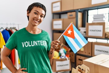 Sticker - Young hispanic woman wearing volunteer uniform holding cuba flag at charity center