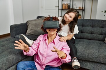 Wall Mural - Mature mother and down syndrome daughter at home playing virtual reality video games