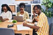 © Krakenimages.com - African american friends business workers sitting on table talking on the telephone working at office
