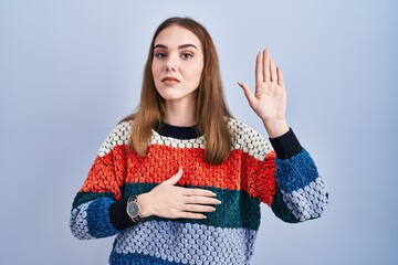 Sticker - Young hispanic girl standing over blue background swearing with hand on chest and open palm, making a loyalty promise oath